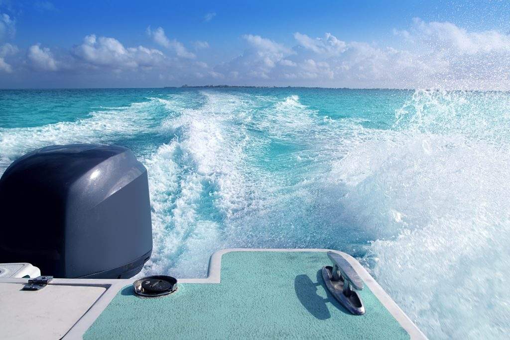 boat outboard stern with prop wash foam caribbean sea