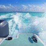 boat outboard stern with prop wash foam caribbean sea